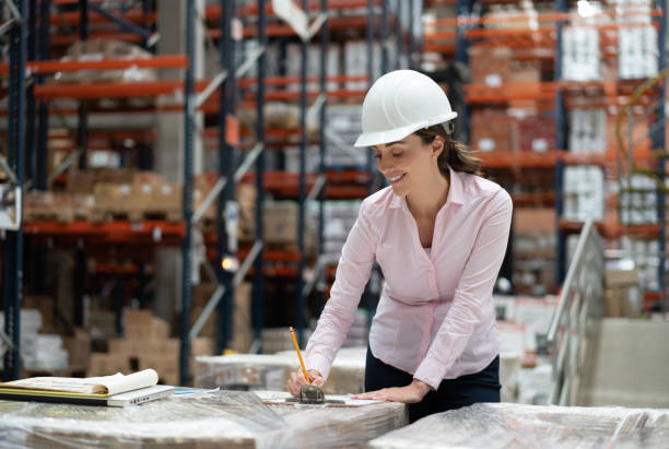 Woman working as manager at a warehouse and looking happy while processing orders