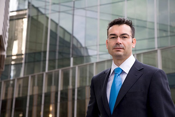 Businessman outside his office in Barcelona. Selective focus on man.